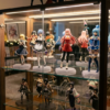 Anime figure display cabinet lit with soft neutral-white LEDs